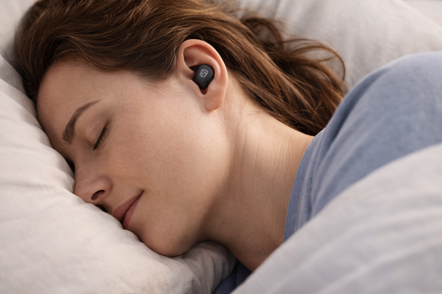 A comfortable side sleeper wearing Soundcore Sleep A30 earbuds to block noise.